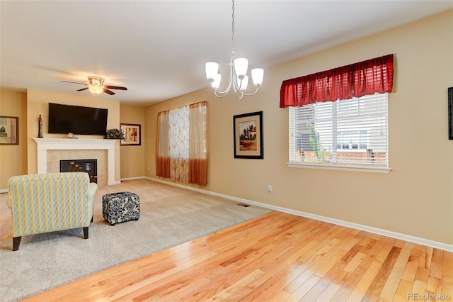 12513 Grape St, Thornton, CO 80241 - living room featuring hardwood / wood-style floors, a chandelier, a tiled fireplace, and ceiling fan