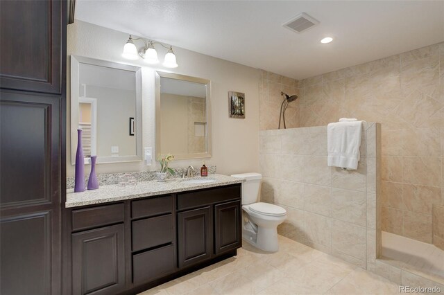 12513 Grape St, Thornton, CO 80241 - bathroom featuring a walk in shower, vanity, and tile patterned floors