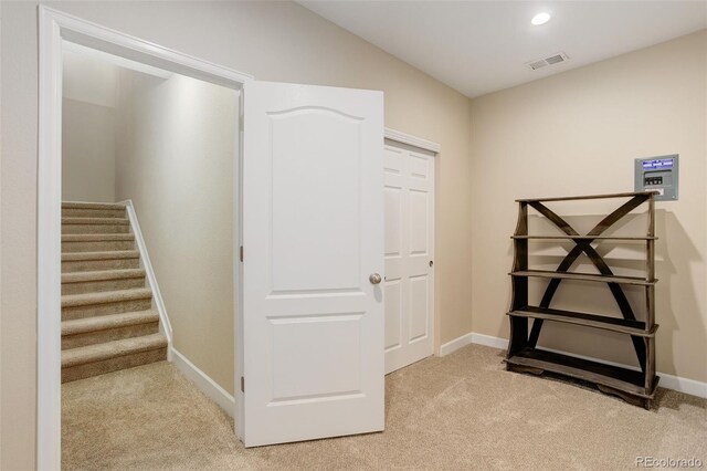 12513 Grape St, Thornton, CO 80241 - hallway with light colored carpet, stairs, and recessed lighting