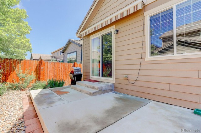 12513 Grape St, Thornton, CO 80241 - doorway to property with a patio