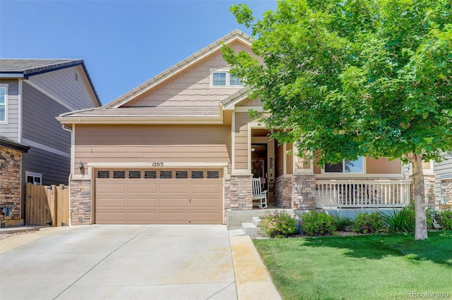 12513 Grape St, Thornton, CO 80241 - view of front facade featuring concrete driveway, covered porch, stone siding, and a tiled roof