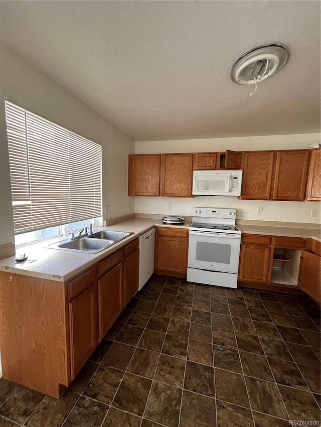 4361 Argonne St, Denver, CO 80249 - kitchen with white appliances, light countertops, and brown cabinetry