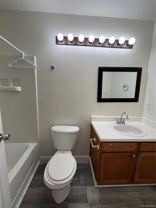 full bathroom featuring hardwood / wood-style floors, vanity, toilet, and shower / bathing tub combination