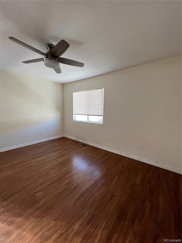 empty room featuring a textured ceiling, ceiling fan, and dark hardwood / wood-style floors