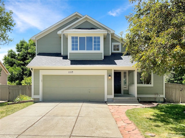 view of front of home featuring a garage and a front lawn