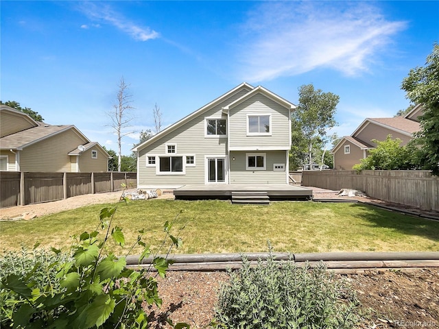 back of house with a yard and a wooden deck