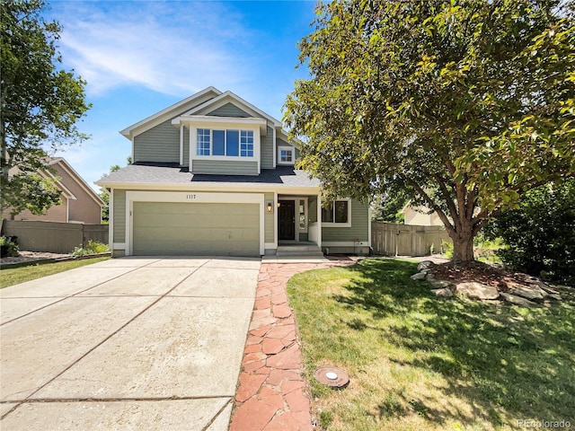 view of front of home with a garage and a front lawn