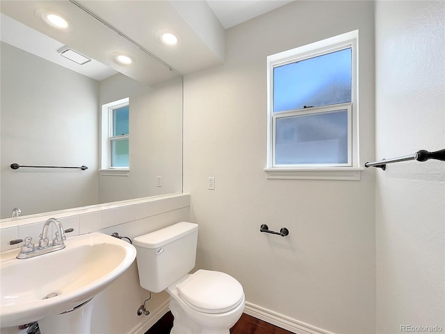 bathroom featuring sink, wood-type flooring, and toilet