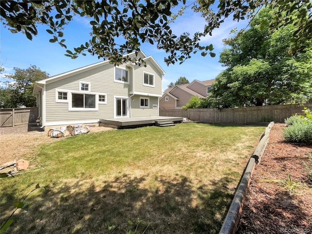 back of house featuring a deck and a yard