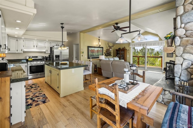 7260 Remington Rd, Como, CO 80432 - kitchen featuring stainless steel appliances, dark countertops, under cabinet range hood, a center island, and ceiling fan