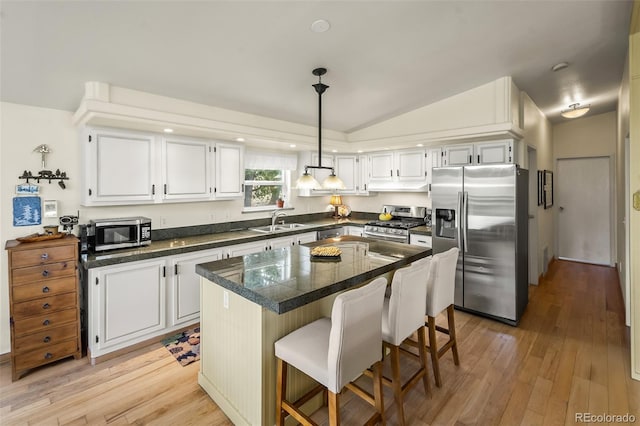 7260 Remington Rd, Como, CO 80432 - kitchen featuring appliances with stainless steel finishes, tile countertops, a sink, white cabinetry, and lofted ceiling