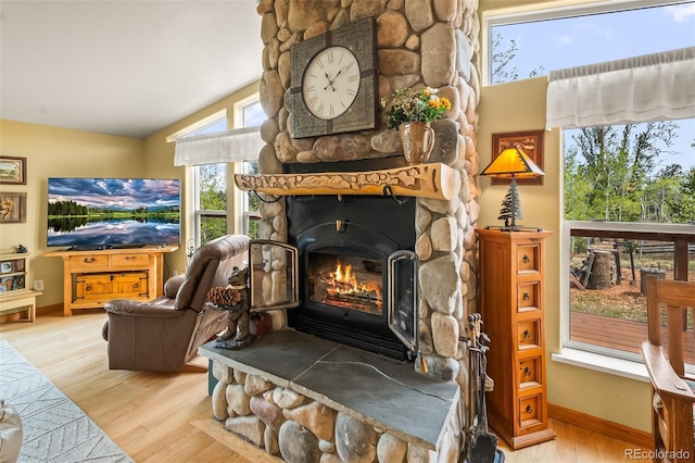 7260 Remington Rd, Como, CO 80432 - living area featuring vaulted ceiling, wood finished floors, a fireplace, and baseboards