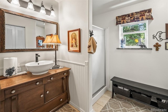 7260 Remington Rd, Como, CO 80432 - bathroom with vanity, a stall shower, tile patterned floors, and wainscoting