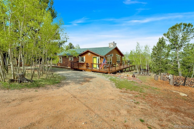7260 Remington Rd, Como, CO 80432 - back of property with a deck, a chimney, driveway, and log veneer siding