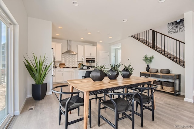 6581 E 148th Dr, Thornton, CO 80602 - dining space with light wood-type flooring, stairway, and recessed lighting