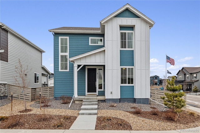 view of front of property with board and batten siding and fence