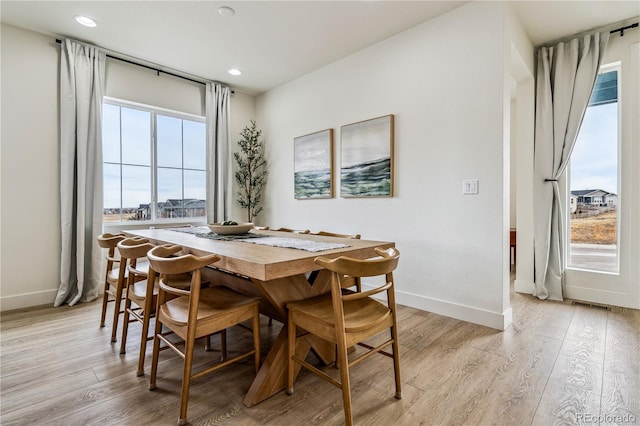 dining room featuring baseboards, recessed lighting, and light wood-type flooring