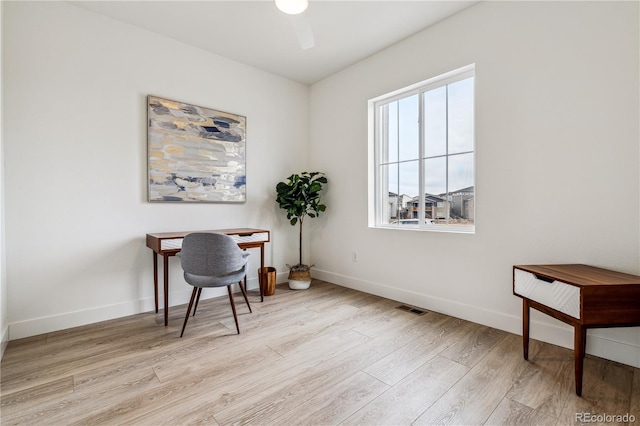 home office featuring baseboards, ceiling fan, visible vents, and wood finished floors