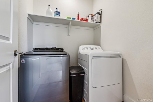 washroom with washing machine and clothes dryer and laundry area