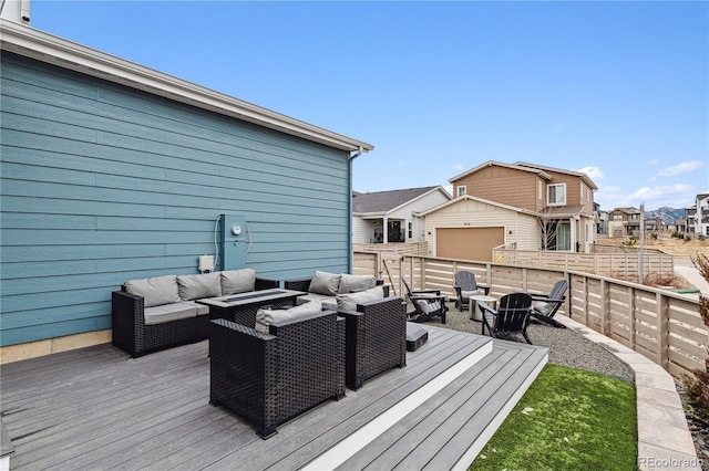 wooden deck with fence, an outdoor living space with a fire pit, and a residential view