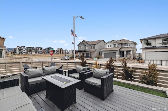 wooden terrace featuring a residential view and an outdoor hangout area