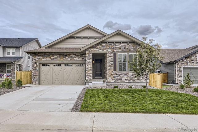 15376 Ivanhoe Ct, Thornton, CO 80602 - craftsman house featuring driveway, an attached garage, stone siding, and board and batten siding