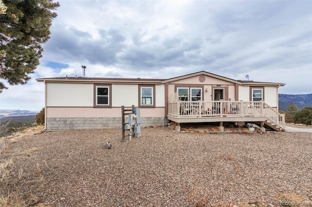 back of house with a deck with mountain view