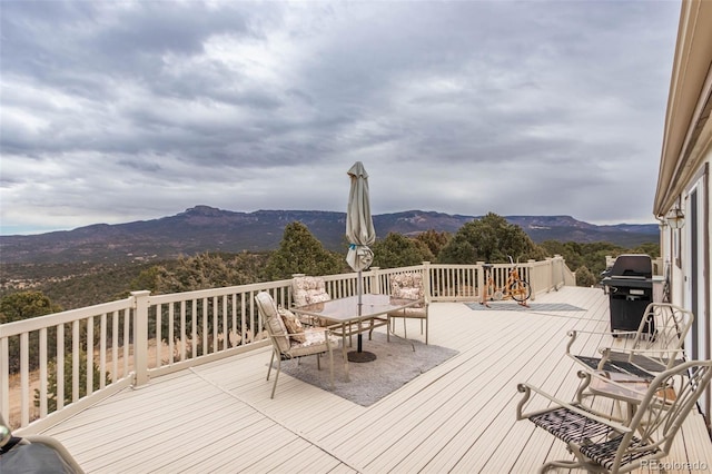 wooden terrace featuring a mountain view and grilling area