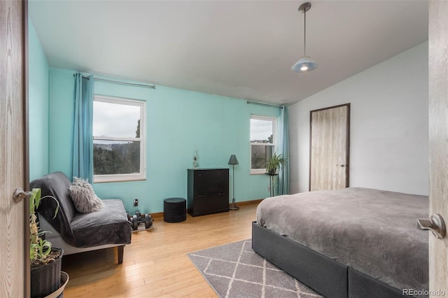 bedroom featuring wood-type flooring and vaulted ceiling