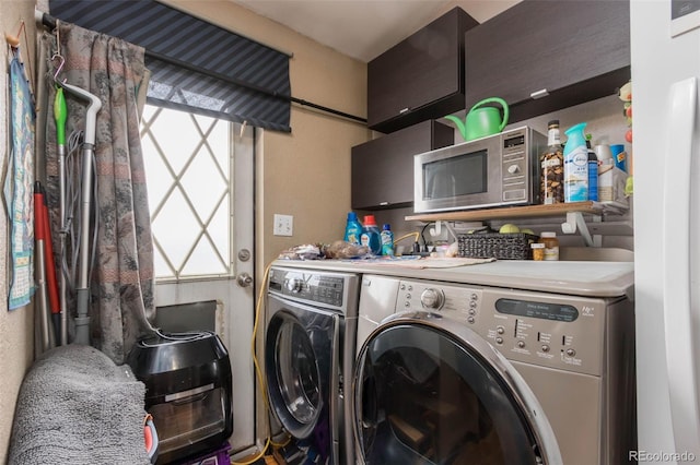 laundry area with cabinets and washer and dryer