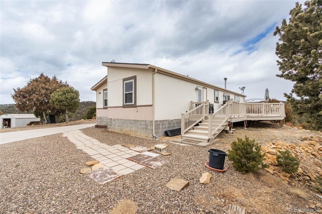 view of property exterior featuring a wooden deck