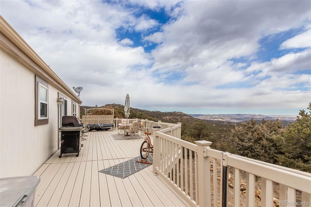 deck with a mountain view and area for grilling