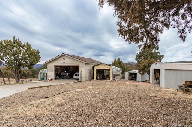 view of front of home featuring a storage shed and a garage