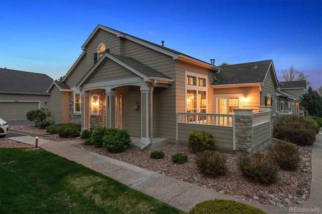 6033 Trailhead Rd, Highlands Ranch, CO 80130 - view of front of home with stone siding and roof with shingles