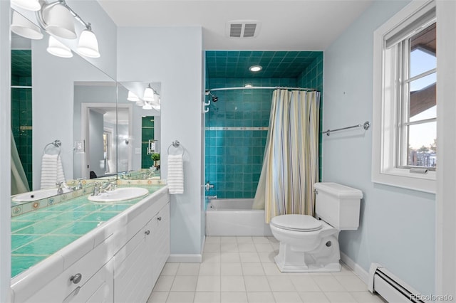 bathroom with visible vents, vanity, baseboards, tile patterned floors, and a baseboard heating unit