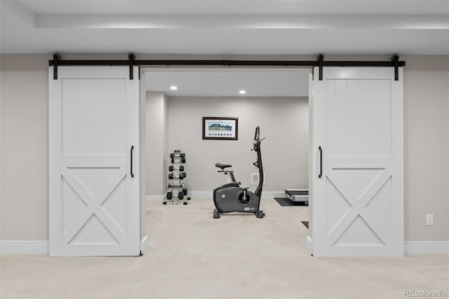 exercise area with baseboards, carpet, recessed lighting, and a barn door