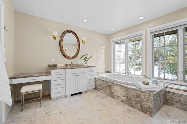 full bathroom with vanity, recessed lighting, and a bath