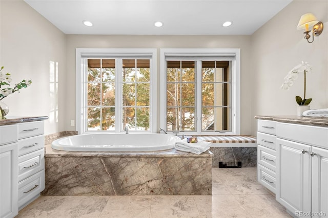 full bathroom with vanity, a garden tub, recessed lighting, and visible vents