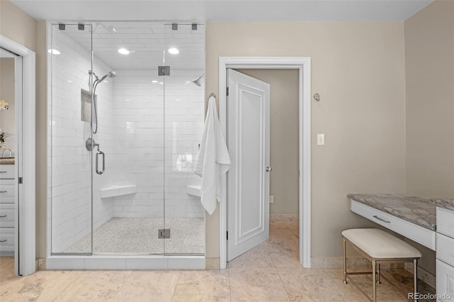 full bath with baseboards and a shower stall