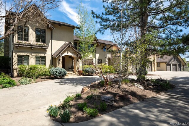 view of front of home featuring concrete driveway and stucco siding