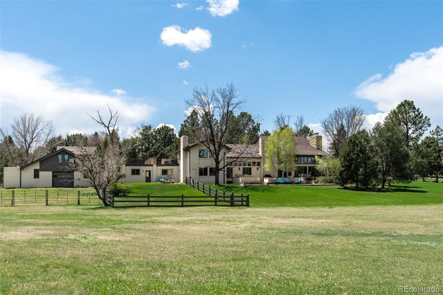 view of home's community featuring a lawn and fence