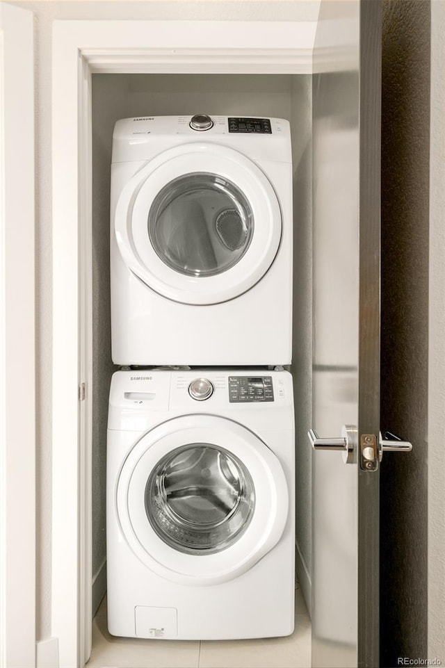 laundry area featuring stacked washer / drying machine