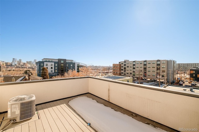 balcony with a city view and central AC unit