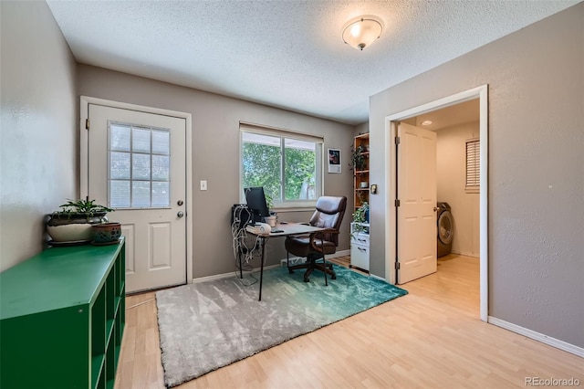 305 Cottonwood Ct, Longmont, CO 80501 - office area with light wood-style floors, a textured ceiling, washer / dryer, and baseboards