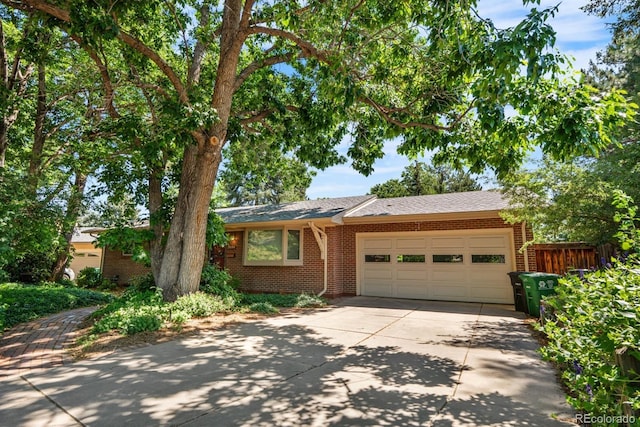 2698 S Niagara St, Denver, CO 80224 - ranch-style home featuring concrete driveway, a garage, and brick siding
