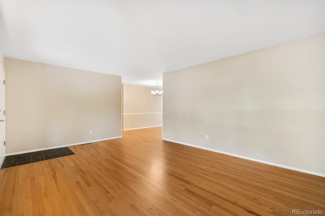 2698 S Niagara St, Denver, CO 80224 - empty room featuring a chandelier and wood finished floors