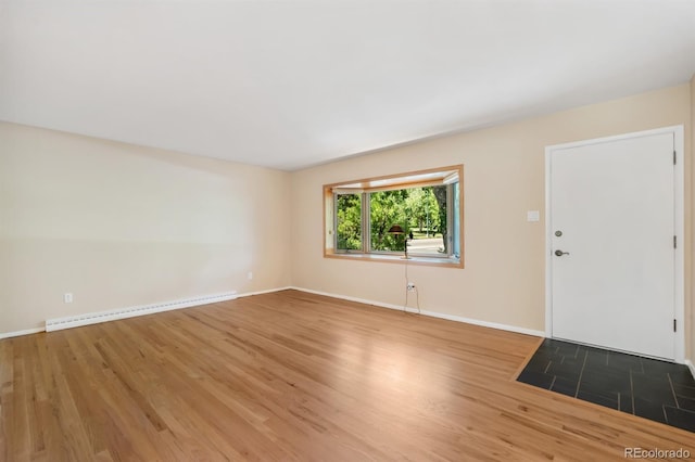 2698 S Niagara St, Denver, CO 80224 - unfurnished living room with a baseboard heating unit and wood finished floors