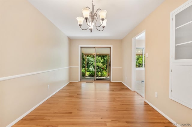 2698 S Niagara St, Denver, CO 80224 - unfurnished dining area with a chandelier and light wood finished floors