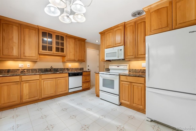 2698 S Niagara St, Denver, CO 80224 - kitchen with white appliances, glass insert cabinets, light floors, a chandelier, and dark stone counters