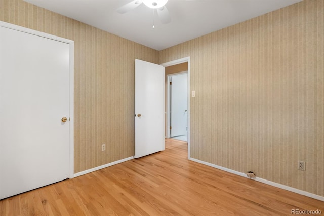 2698 S Niagara St, Denver, CO 80224 - spare room featuring wood finished floors, ceiling fan, and wallpapered walls